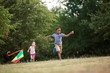 © Robert Kneschke - Girl and boy flying a kite