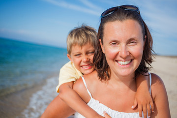 Wall Mural - Mother and son playing on the beach.