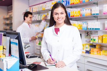 Wall Mural - pharmacist standing at pay desk