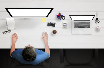 Leinwandbilder - Man work on computer with white isolated screen. Work desk with laptop, paper, camera, coffee, smart phone, notepad, pens, glasses, calculator, scissors. Top view.