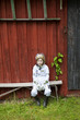 © Johnér - Boy wearing knight costume sitting on bench