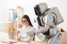 Pleasant Girl And Robot Working In The Office 