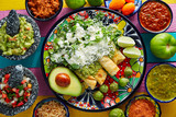 Fototapeta Miasta - Green enchiladas Mexican food with guacamole