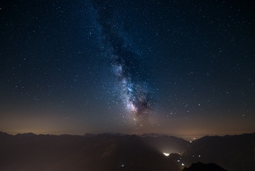 Wall Mural - glowing milky way and starry sky from the alps