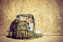 Hiking Backpack Camping Equipment Outdoor On Grunge Wall