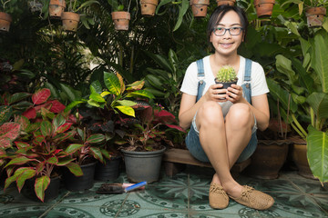 Woman holding a cactus