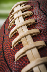 Wall Mural - Macro of a vintage worn american football ball with visible laces, stitches and pigskin pattern