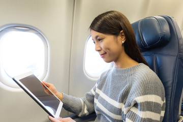 Poster - Woman use of digital tablet in aircraft