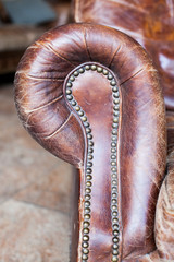 Wall Mural - Closeup texture of vintage brown leather armchair in library