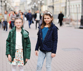 Two kid girls on city streets