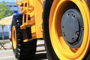 Wall Mural - Big black wheel yellow construction truck with steps