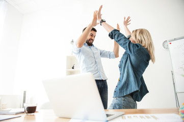 Pretty two workers are celebrating their success