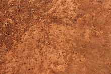 Dry Red Soil And Small Rock In Thailand.