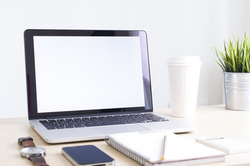 Laptop with coffee cup on work desk background