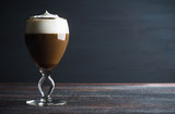 Irish coffe on the dark wooden background