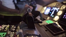 Detail Shot Of Airline Pilot Pushing Throttle Forward In The Cockpit Of A Jumbo Jet.  Side View, Hand-held Camera, Originally Recorded In 4K.