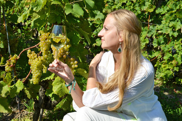 Wall Mural - Girl tasting white wine among vineyards. Lavaux, Switzerland