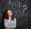 © shefkate - Young girl with question mark on a gray background