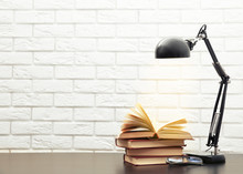 Modern Lamp And Books On The Desk On White Wall Background