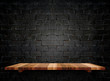 Empty wooden shelfs on pastel grunge black brick wall, Mock up t