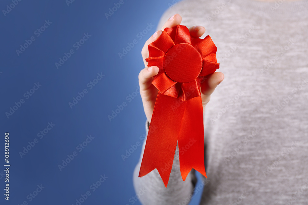 Woman with award ribbon. close-up