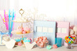 © Africa Studio - Baby shower celebration table with pink and blue cupcakes, candies, photo albums, and pacifiers for newborn party