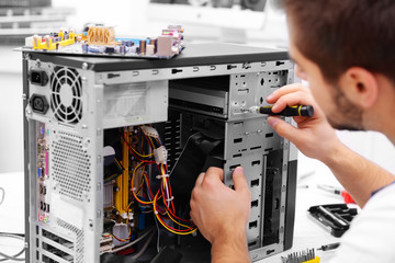 young repairer working with screwdriver in service center