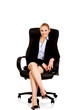 © Piotr Marcinski - Young smile business woman sitting on a chair in office