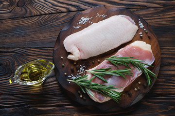 Poster - Raw fresh duck breast filet in a rustic wooden setting, top view