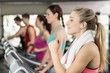 © WavebreakMediaMicro - Fit woman running on the treadmill while listening music