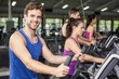 © WavebreakmediaMicro - Fit people on elliptical bike