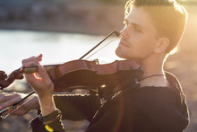 Handsome Young Man Violinist Over Picturesque Background