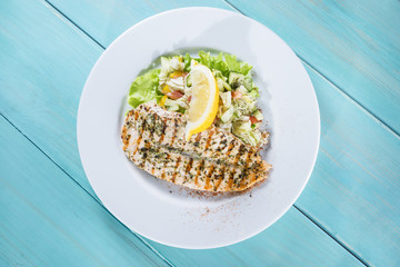 Wall Mural - salmon fillet on the grill serve fresh salad and lemon