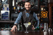 © Dmytro Panchenko - Barman serving cocktail.