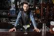 © Dmytro Panchenko - Barman serving cocktail.