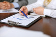 © rogerphoto - Close up  of unknown  business people at meeting discussing financial results
