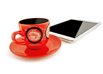 Red cup with a saucer and the tablet computer on a white backgro