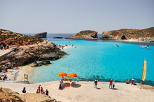 BLUE LAGOON, COMINO, MALTA - APRIL 13, 2016. People Enjoy Blue Lagoon  With Crystal Clear Blue Water.