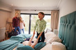 © Monkey Business - Family On Vacation With Children Playing On Hotel Bed