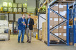© Westend61 - Two managers discussing packaging and shipment in storage hall