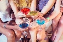 Girls With Cocktails Toasting In A Club
