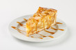© dimamoroz - Delicious apple pie charlotte with caramel on the plate on white background. Close up side view.