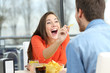 Playful couple eating chip potatoes