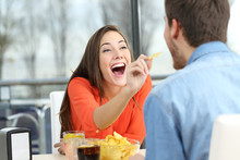 Playful Couple Eating Chip Potatoes