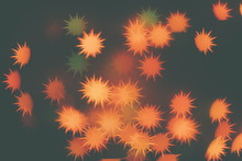 Many Orange Snowflakes On A Dark Background. Design Wallpaper.