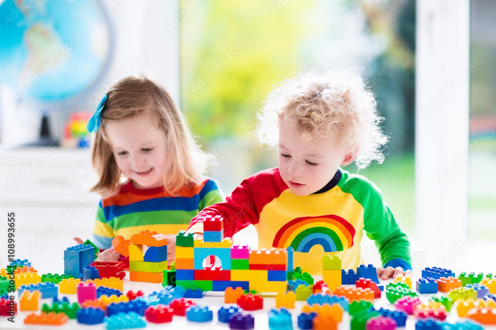 Kids playing with colorful plastic blocks Stock Photo | Adobe Stock