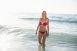 © WavebreakmediaMicro - Young woman in bikini standing in water