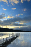 Fototapeta Pomosty - Sunset On The Lake - Traditional wooden dock and its beautiful reflection in the water in the sunset