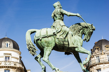 Wall Mural - Monument of Jeanne d'Arc (Joan of Arc) on Place du Martroi in perspective of street in Orleans, France