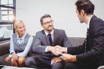 Confident business people handshaking